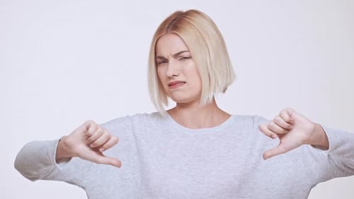 Woman Gives Two Thumbs Down in Disgust