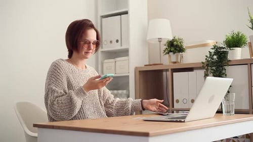 Woman Working at Desk with Tablet and Laptop