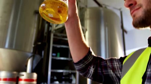 Close-up of brewer testing beer
