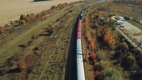 Long Freight Train with Building Materials is Moving by Railway