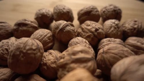Pile of Walnuts on Wooden Background, Close Up
