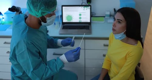 Healthcare worker doing coronavirus swab test to young woman