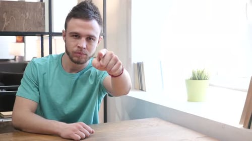Young Man Points Directly at the Viewer