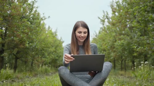 Woman Using Laptop While Sitting Outdoors