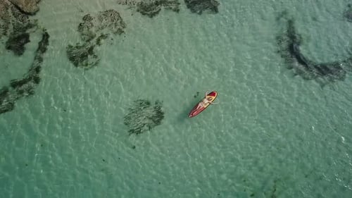 Woman Relaxing in the Sea on a Surfboard