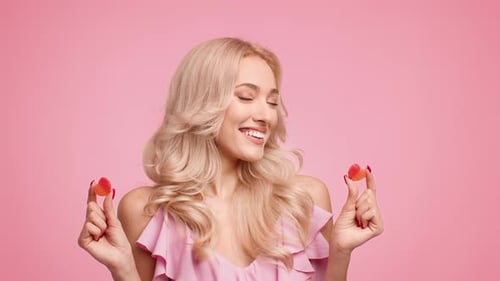 Smiling Woman Holding Two Gummy Candies