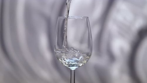 White wine being poured in a glass