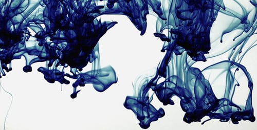 Blue Ink Swirling Abstractly on White Background