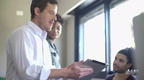 Colleagues collaborating in office