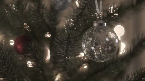 Decorating Christmas Tree with Silver Ornaments