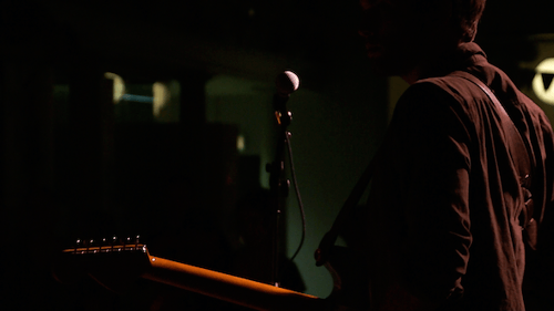 Microphone Stand at Concert Venue with Live Music