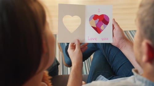 Couple Reads 'I Love You' Card at Home
