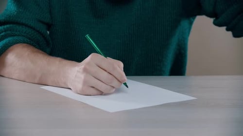 A Man Is Going To Write Words Down on the Table