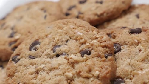 Bunch of chocolate chip cakes close-up tilting 4K 2160p 30fps UltraHD video - Biscuit cookies with p