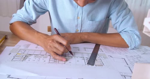 Male Architect Working On A Building Blueprint