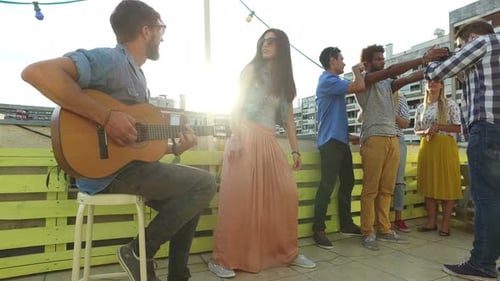 Friends Celebrate with Music on City Rooftop