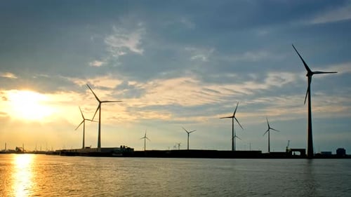 Wind Turbines in Antwerp Port on Sunset.