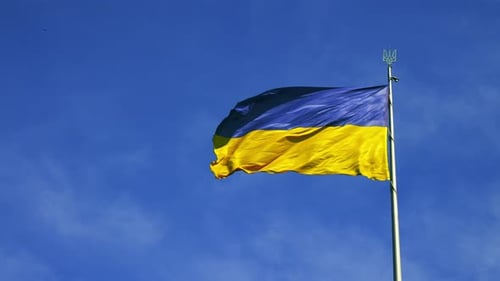 Ukrainian Flag Waving Against a Blue Sky