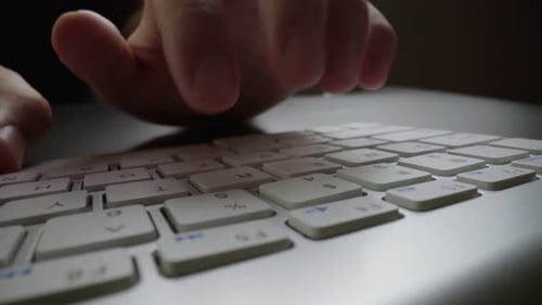 Closeup Typing on Keyboard with Man Fingers