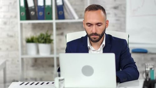 Confident Stylish Male Boss Wearing Suit Focused Looking at Screen Laptop Working at Modern Office