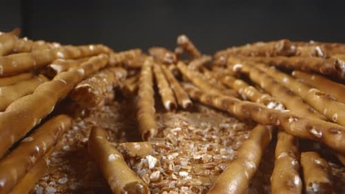 Crispy Pretzel Sticks Piled on Wooden Surface