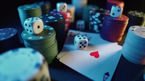Casino Chips with Dice and Playing Cards on a Dark Table