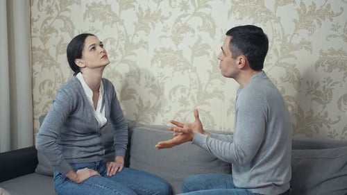 Couple Arguing on Couch in Domestic Setting
