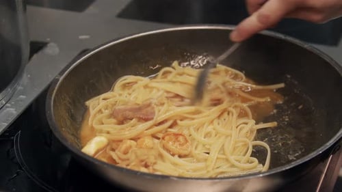 Restaurant Cooking Chef Cooks Pasta with Bacon in a Frying Pan