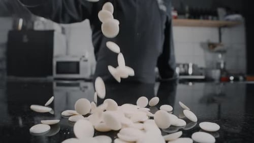 White Candy Pieces Falling onto Kitchen Countertop