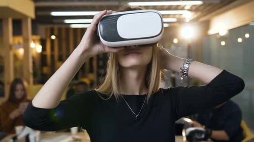Handsome Young Woman Wearing Virtual Reality VR Glasses on the Office Background
