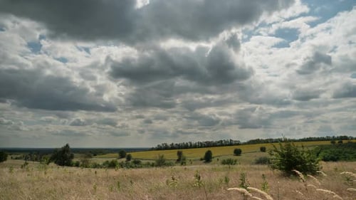Landscape Dramatic Fields and Moving Storm Clouds in Blue Sky. Timelapse. Amazing Rural Valley