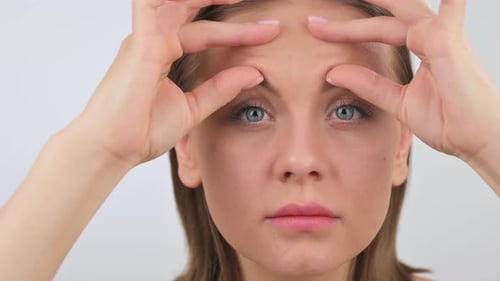 Portrait of Young Woman Displeased with Wrinkles on Her Forehead