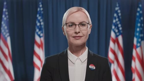 Blonde Woman Smiling in Front of American Flags