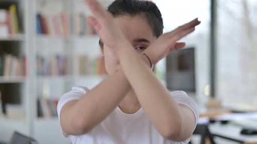 Young Woman Making an X with Her Arms
