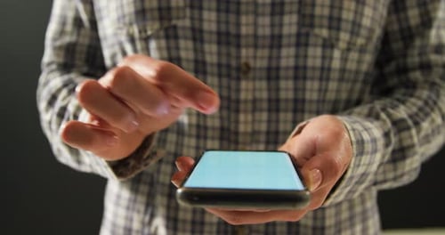 Hand Interacting with Smartphone in Close Up