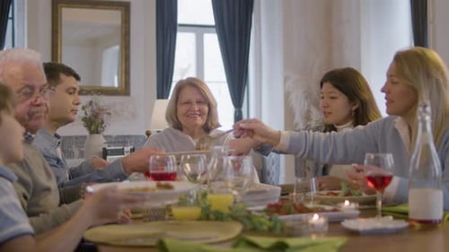 Family Sharing Food at Indoor Dinner Table