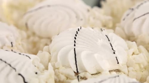 Elegant White Pastries with Black Drizzle Close-Up
