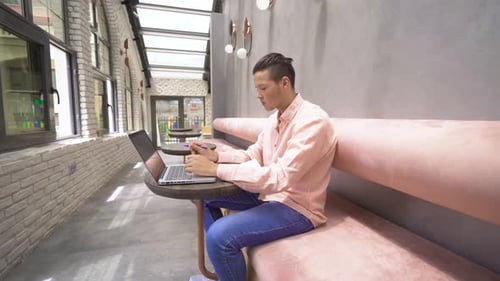 College student working with laptop.