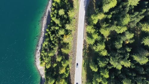The road near turquoise lake. Aerial landscape. The road by the lake in Switzerland.