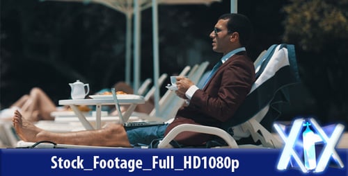 Businessman Works by Pool on Tropical Vacation