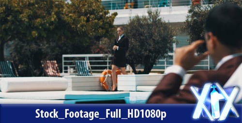 Businesswoman Walks Past Laptop User by Pool