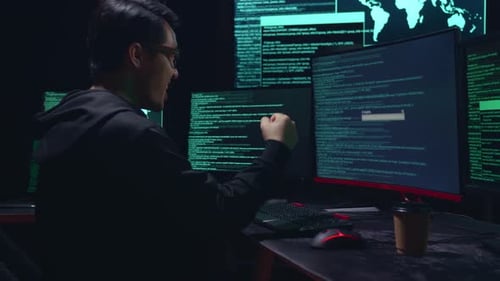 Young Adult Coding With Excitement at Computer