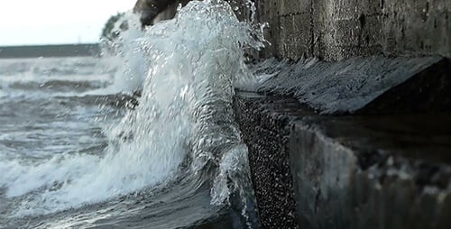Waves Splashing on a Dark Concrete Urban Seawall