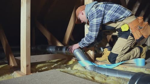 Technician in His 30s Assembly Air Ventilation Pipes