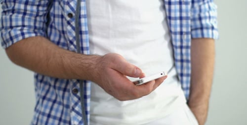 Man Holding Mobile Phone Wearing Casual Attire