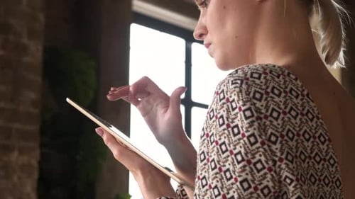 Woman Using Tablet in Indoor Setting