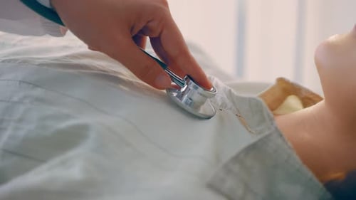 Doctor Listening to Patient Heartbeat with Stethoscope