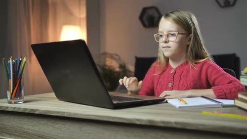Child Studying on Laptop at Night at Home