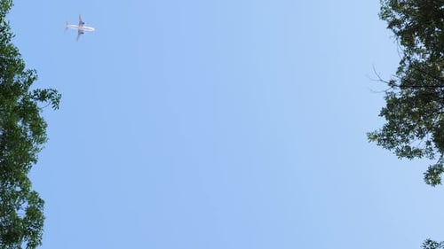 Airplane Flying Across Clear Blue Sky