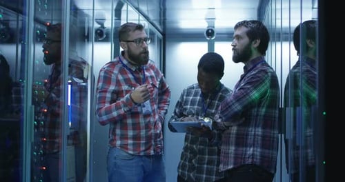 IT Technicians Working in Server Room Analyzing Data